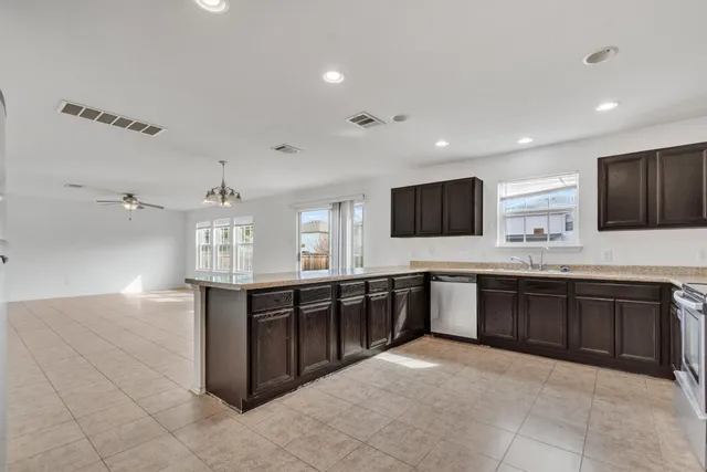 a view of a kitchen with a sink and dishwasher kitchen appliances