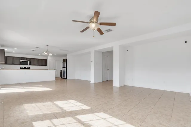 a view of a kitchen with a sink and refrigerator