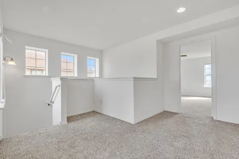 an empty room with windows and closet