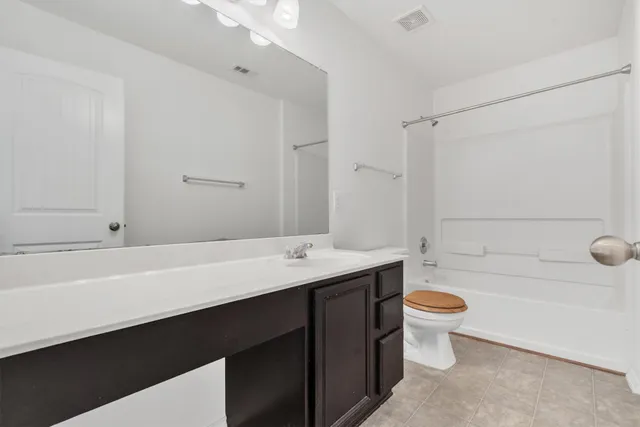 a bathroom with a bathtub a sink a toilet and a shower