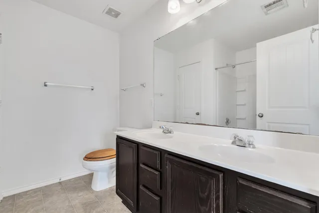 a bathroom with a sink a toilet and a mirror