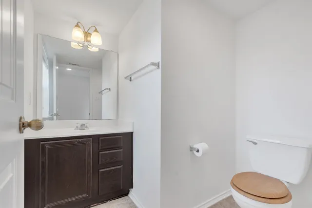 a large kitchen with stainless steel appliances a large counter top a stove and a refrigerator