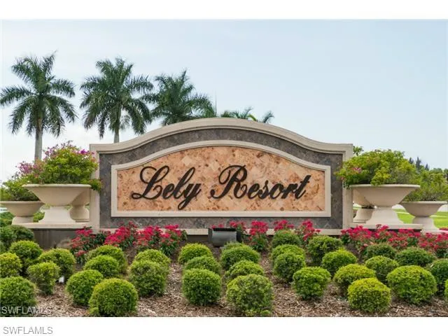 a sign that is sitting in front of flowers