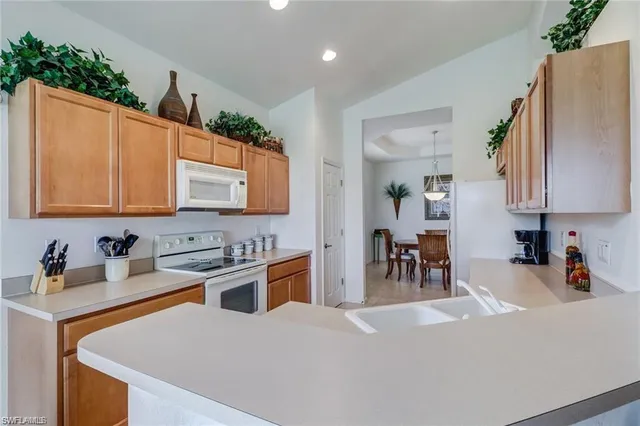 a kitchen with stainless steel appliances a sink stove and cabinets
