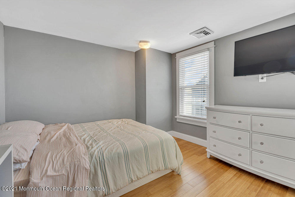 13 Center Street Sea Bright, NJ 07760 - Photo 22 of 56 a bedroom with a bed and a flat screen tv