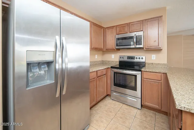 a kitchen with a refrigerator stove and microwave