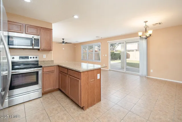 a kitchen with stainless steel appliances granite countertop a stove and a refrigerator