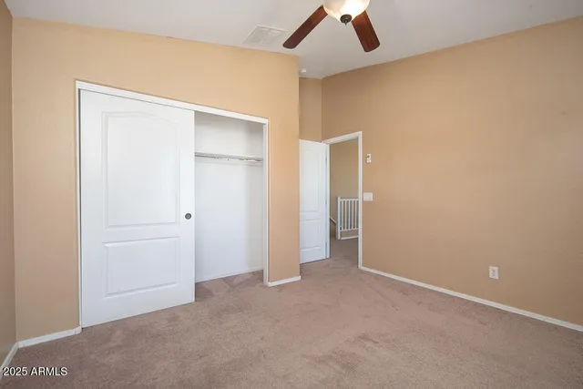 an empty room with closet and bathroom