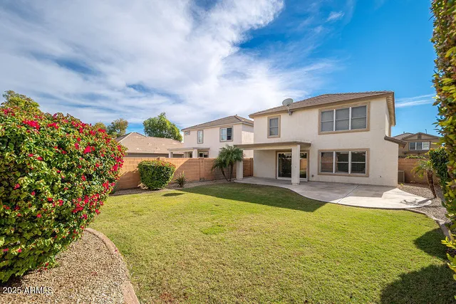 a front view of a house with swimming pool having outdoor seating