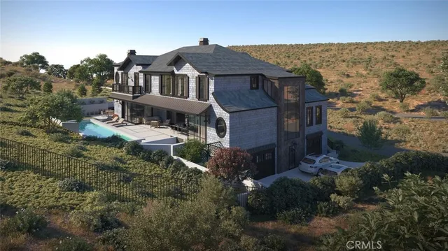 an aerial view of multiple houses with a yard