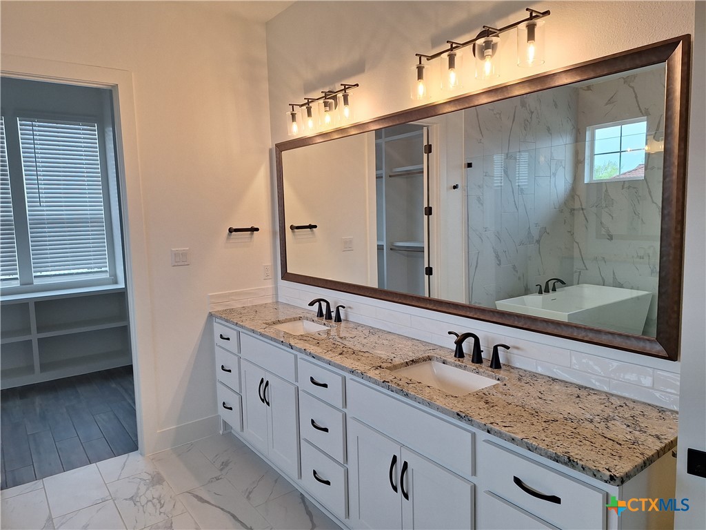 120 Strada Luca Florence, TX 76527 - Photo 13 of 17 a bathroom with a granite countertop double vanity sink and mirror