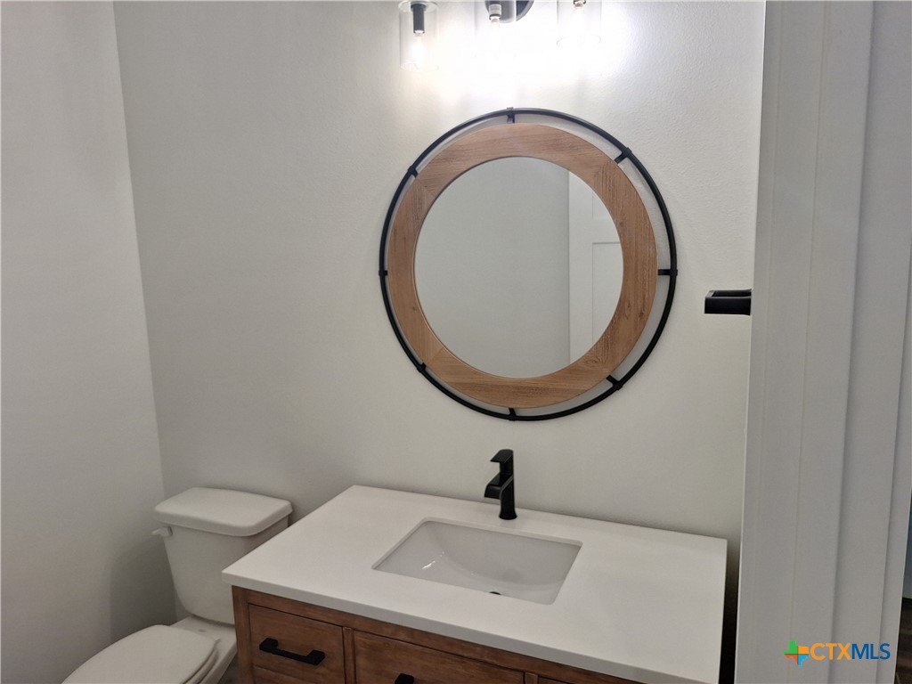 120 Strada Luca Florence, TX 76527 - Photo 14 of 17 a bathroom with a sink a toilet and a mirror