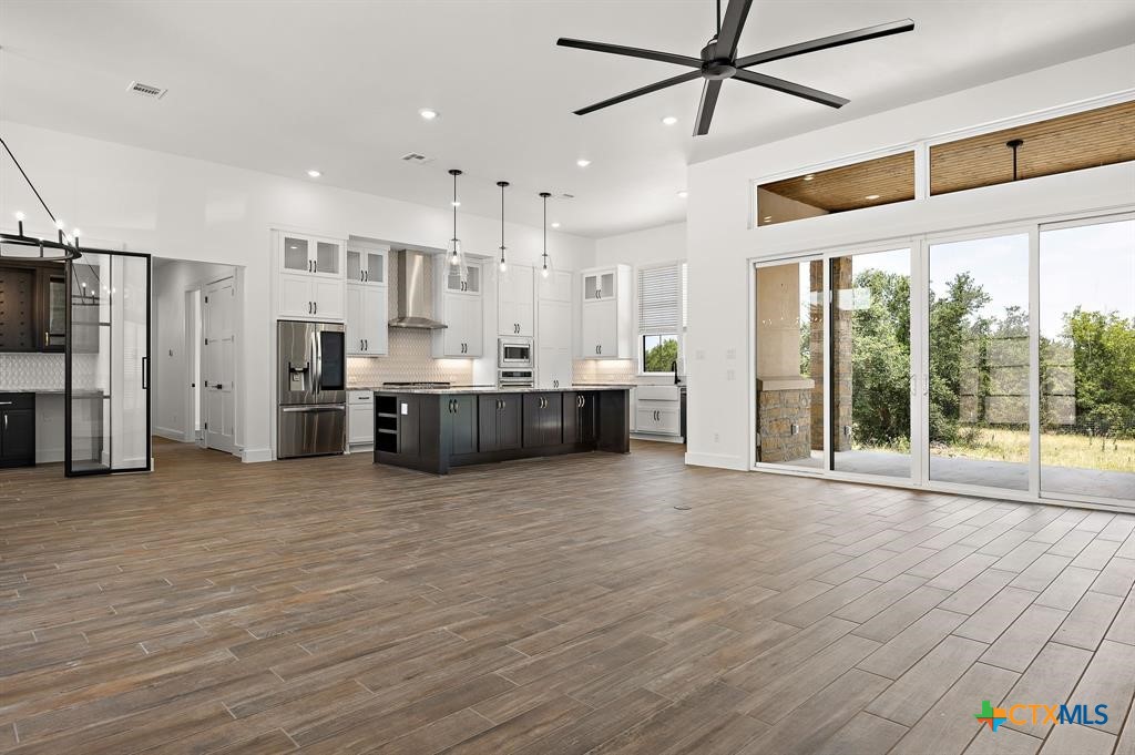 120 Strada Luca Florence, TX 76527 - Photo 8 of 17 a view of kitchen with stainless steel appliances wooden floor and window