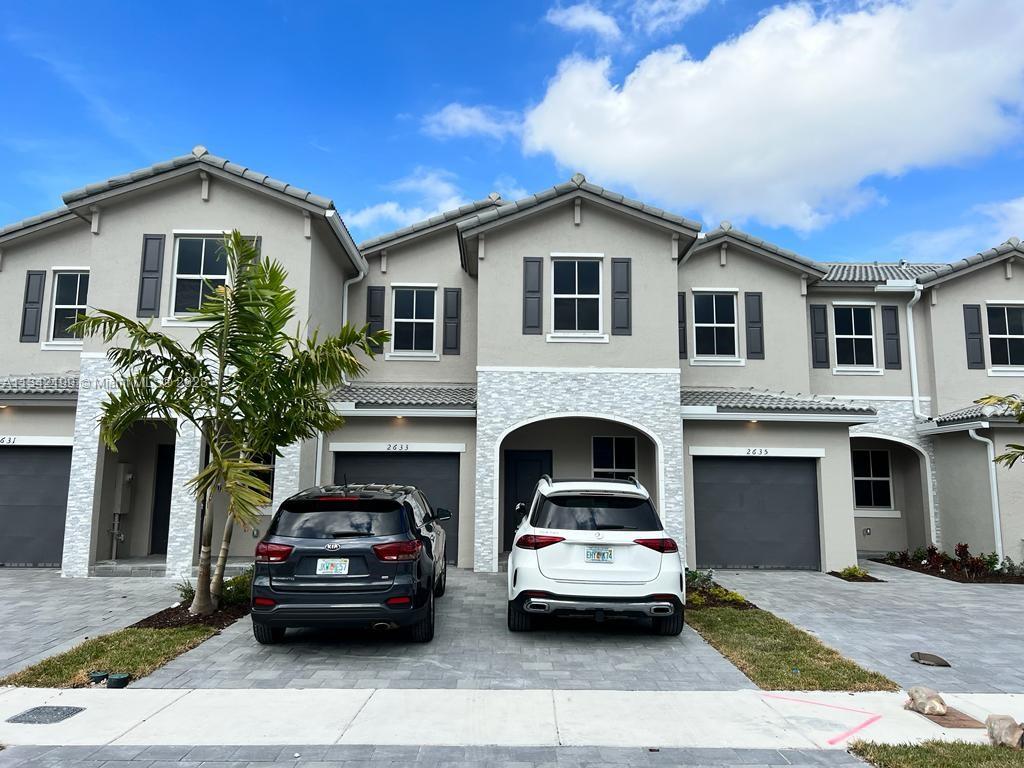 2633 Southeast 10th Street, Unit 2633 Homestead, FL 33035 - Photo 1 of 42 a view of a car parked in front of a house