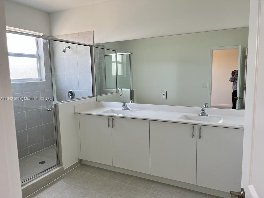 2633 Southeast 10th Street, Unit 2633 Homestead, FL 33035 - Photo 14 of 42 a bathroom with a double vanity sink and a mirror