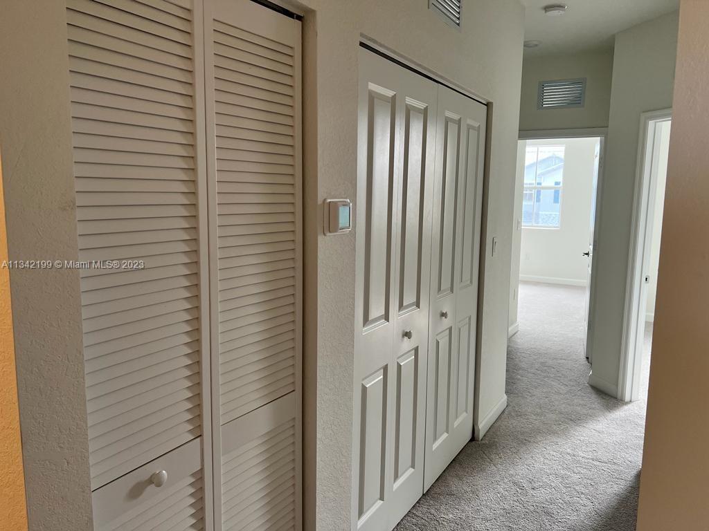 2633 Southeast 10th Street, Unit 2633 Homestead, FL 33035 - Photo 16 of 42 a view of a bathroom from a corridor