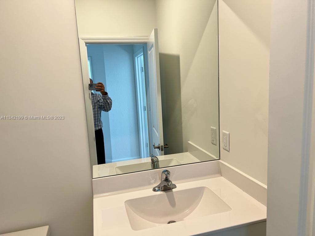 2633 Southeast 10th Street, Unit 2633 Homestead, FL 33035 - Photo 18 of 42 a bathroom with a sink and a mirror