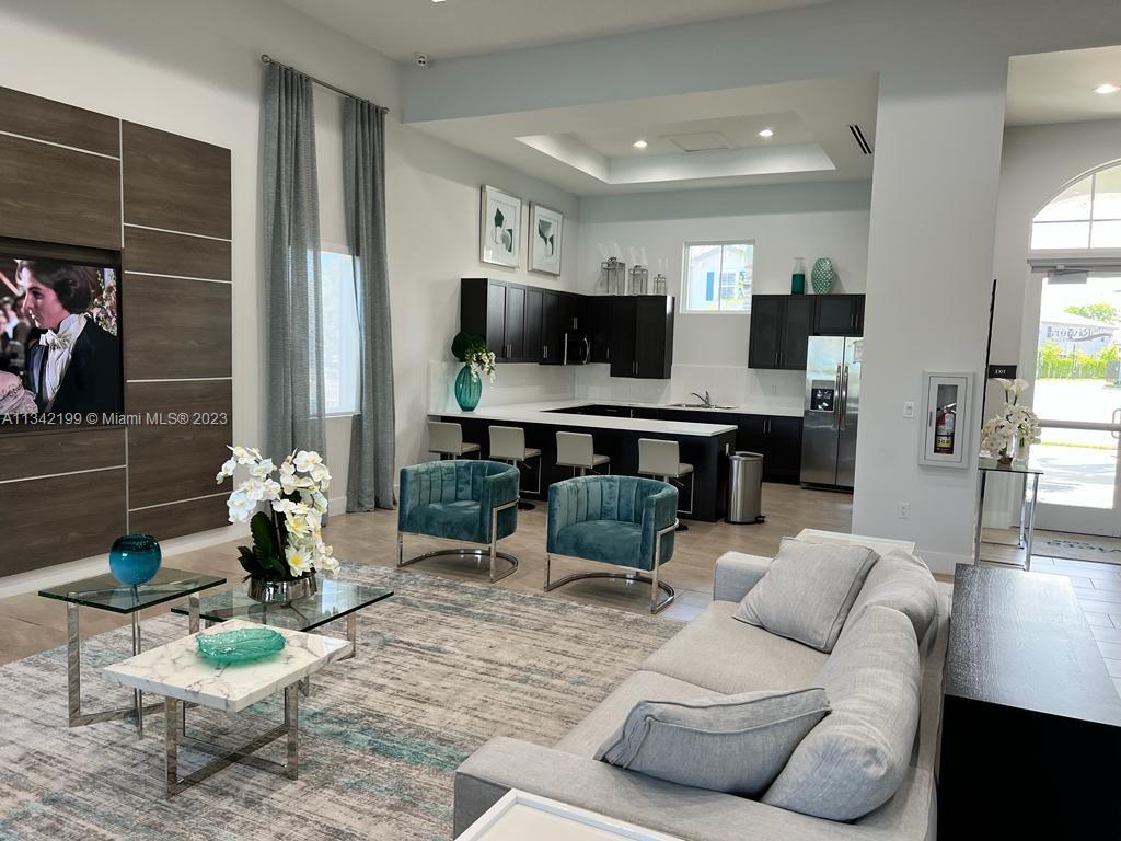 2633 Southeast 10th Street, Unit 2633 Homestead, FL 33035 - Photo 31 of 42 a living room with furniture and a flat screen tv