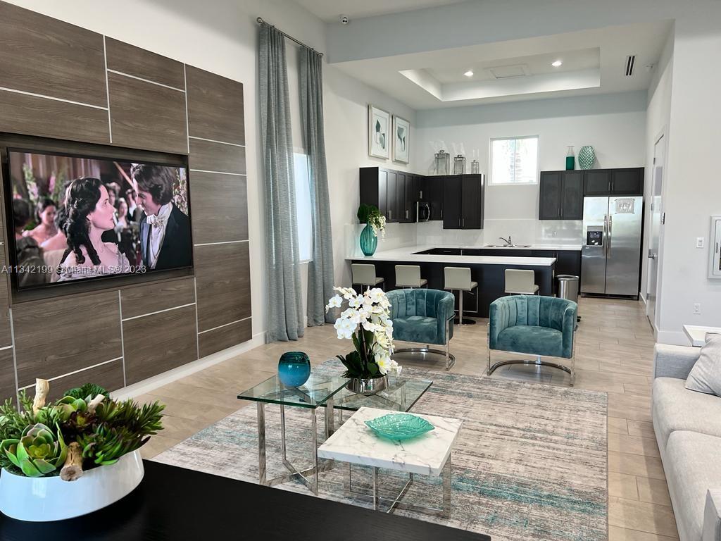 2633 Southeast 10th Street, Unit 2633 Homestead, FL 33035 - Photo 33 of 42 a living room with furniture and a flat screen tv