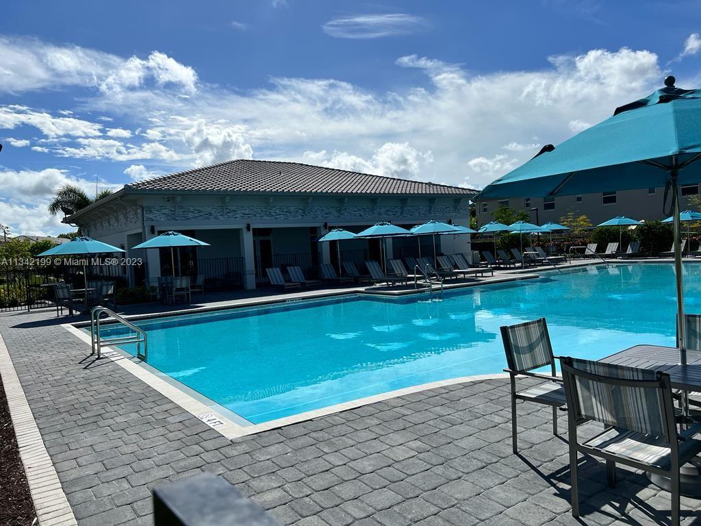 2633 Southeast 10th Street, Unit 2633 Homestead, FL 33035 - Photo 36 of 42 a view of a house with swimming pool and sitting area