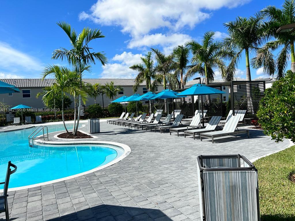 2633 Southeast 10th Street, Unit 2633 Homestead, FL 33035 - Photo 37 of 42 a view of a swimming pool with chairs