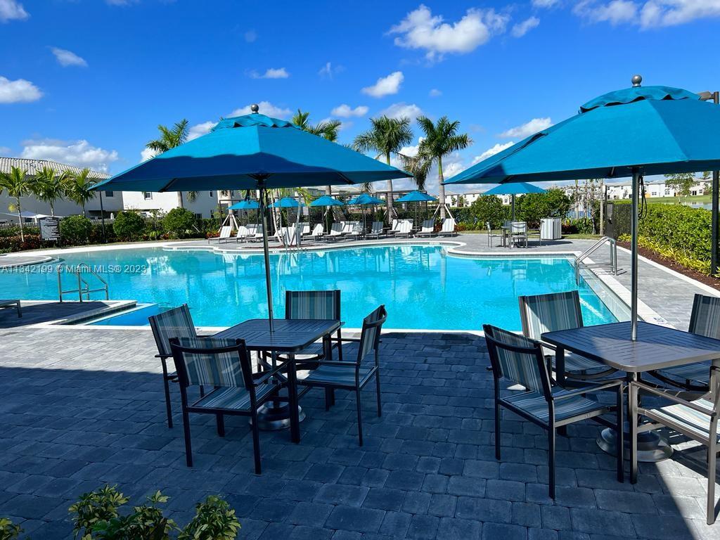 2633 Southeast 10th Street, Unit 2633 Homestead, FL 33035 - Photo 38 of 42 a view of a patio with furniture and a backyard