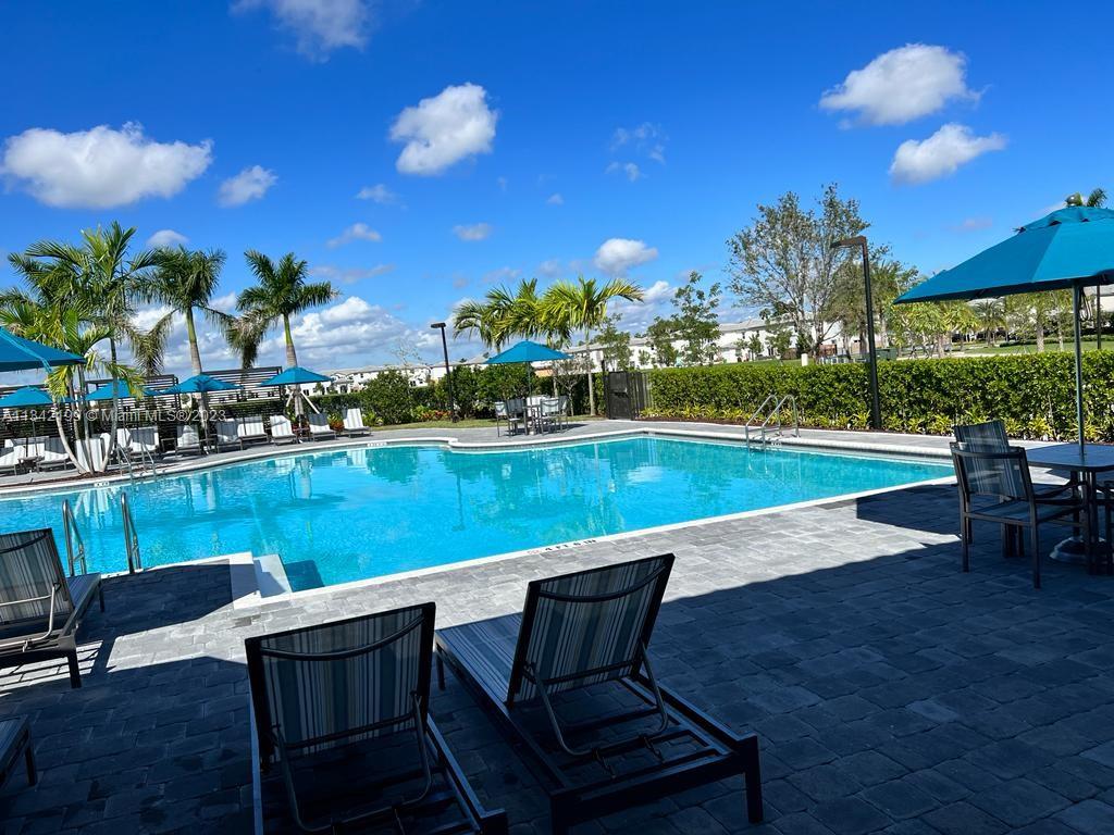 2633 Southeast 10th Street, Unit 2633 Homestead, FL 33035 - Photo 42 of 42 a swimming pool with outdoor seating and yard