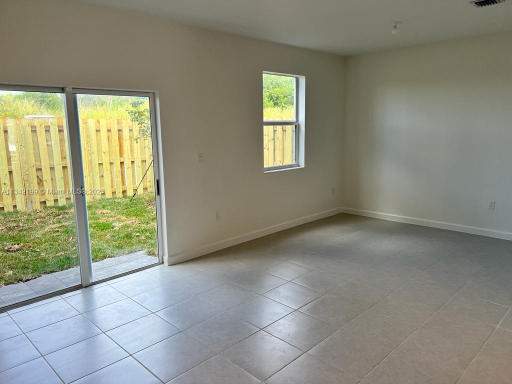 2633 Southeast 10th Street, Unit 2633 Homestead, FL 33035 - Photo 5 of 42 a view of an empty room with a window