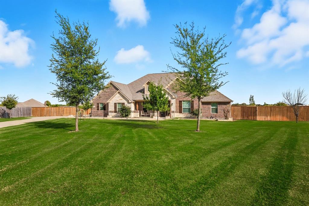 142 High Ridge Court Decatur, TX 76234 - Photo 2 of 40 a view of a house with a big yard