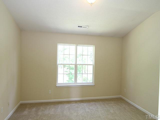 3131 Manhasset Lane Raleigh, NC 27604 - Photo 11 of 21 The master bedroom is 14x12.5 and features a view of the wooded buffer & cathedral ceiling.