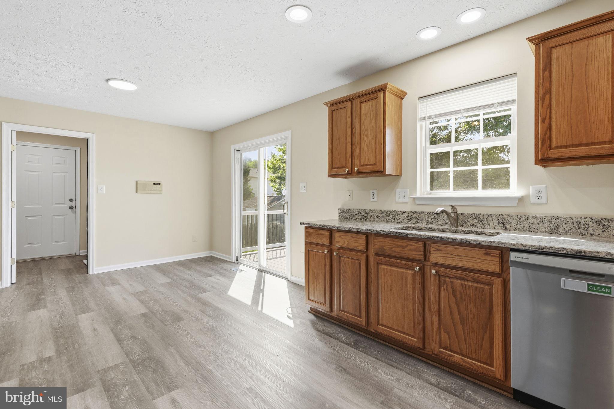 2801 Profitt Path Edgewood, MD 21040 - Photo 6 of 32 a kitchen with granite countertop a stove a sink and wooden floors