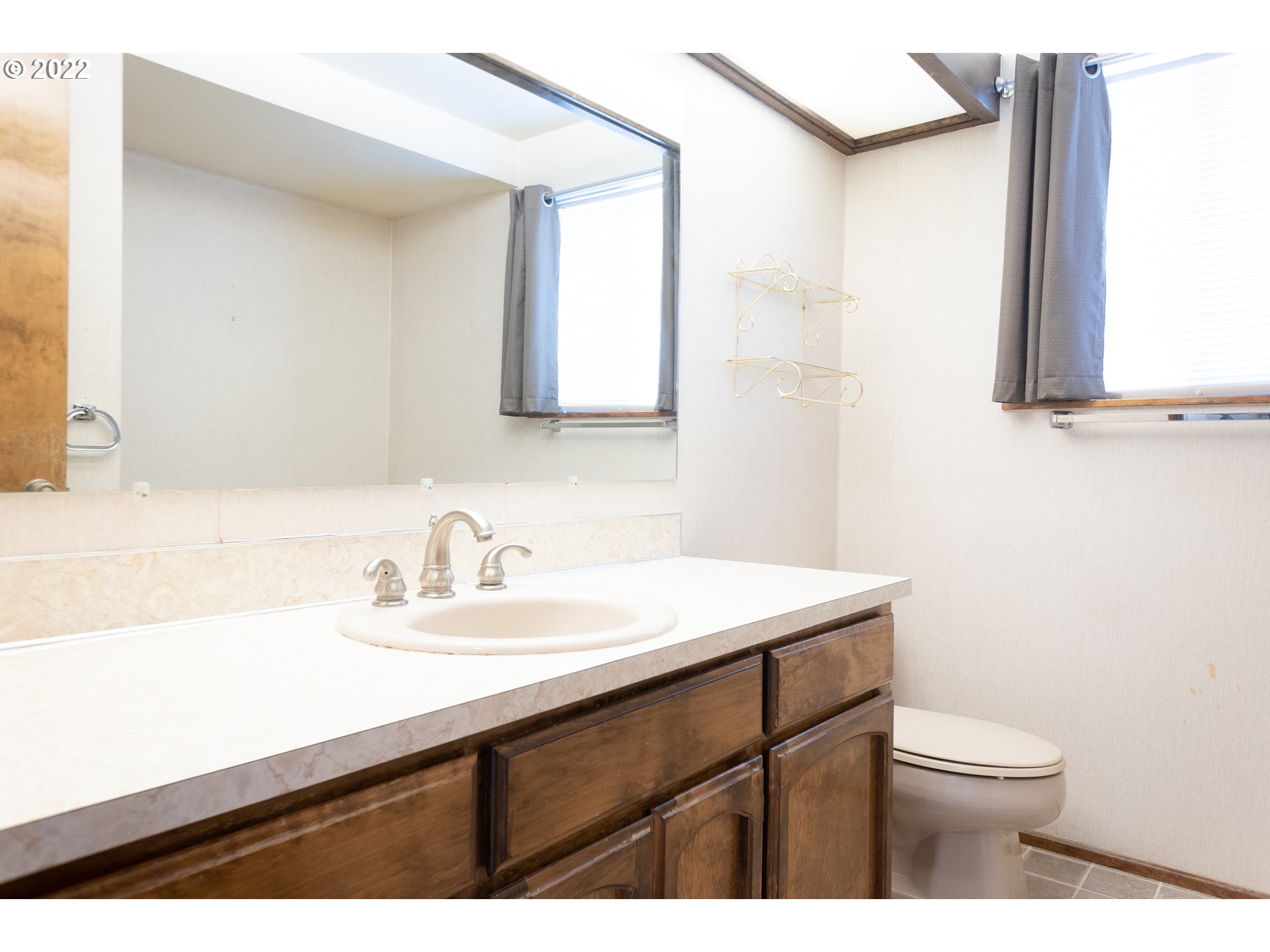 375 72nd Place Springfield, OR 97478 - Photo 21 of 32 a bathroom with a sink a toilet and mirror