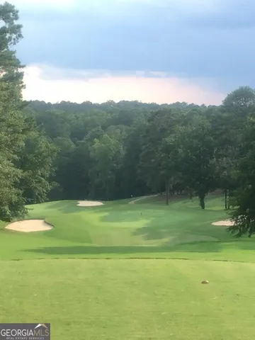 an aerial view of a house with a garden and lake view