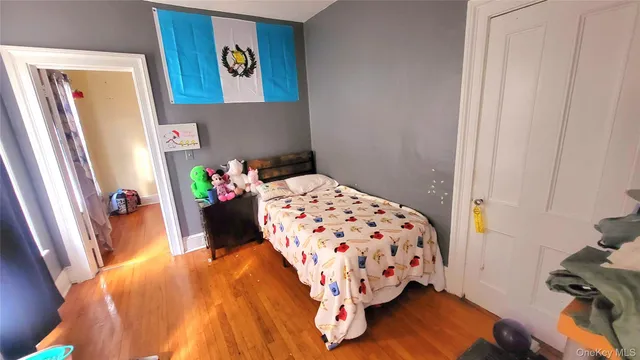 a bed sitting in a bedroom next to a window