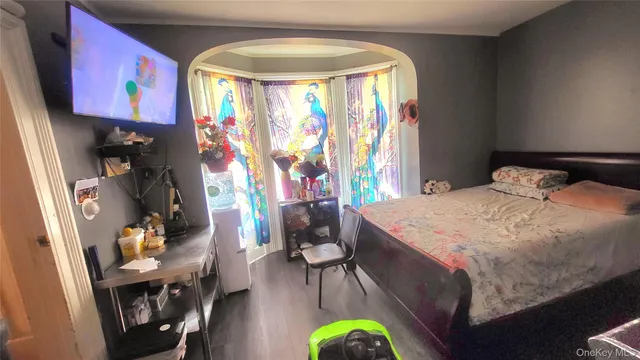 a bedroom with a bed a window and couch