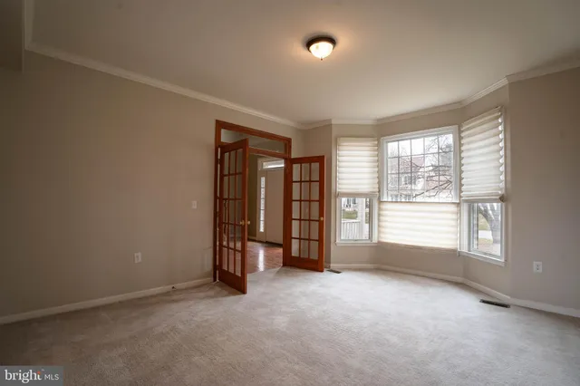 an empty room with a empty space and windows