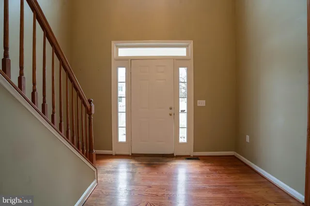 a view of an entryway with wooden floor