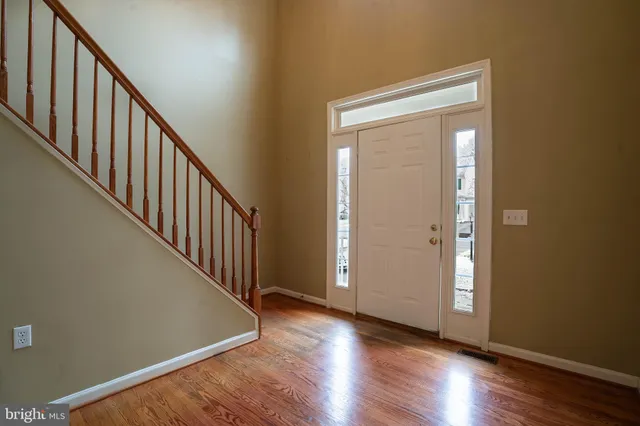 a view of an entryway with wooden floor