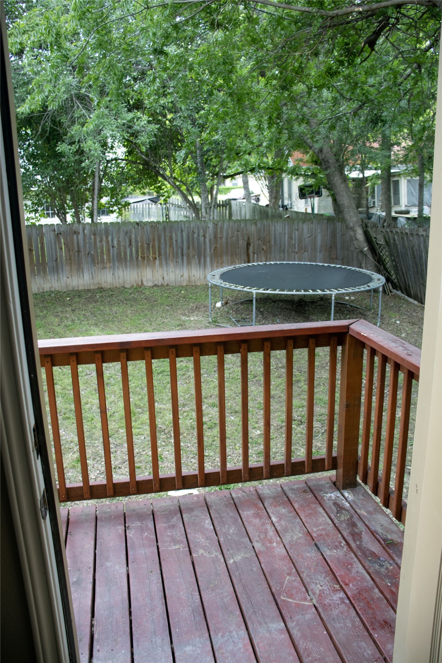 633 South Commerce Street Lockhart, TX 78644 - Photo 19 of 29 Wood-decked patio with a reddish-brown finish and matching railing