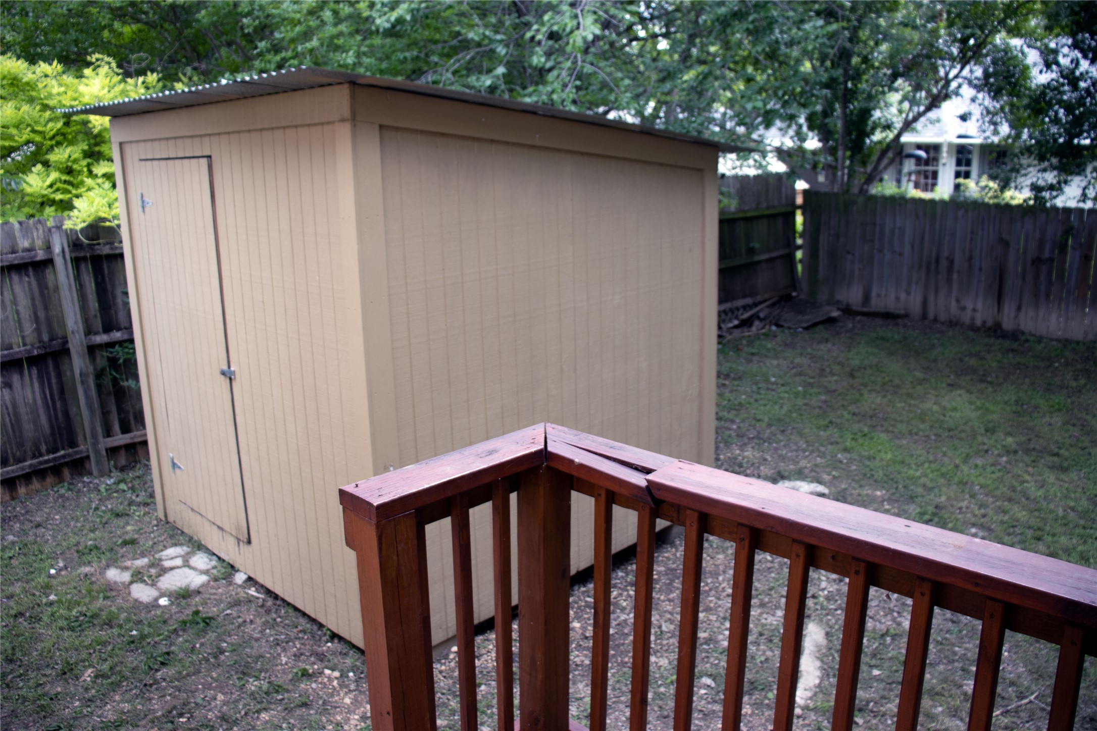 633 South Commerce Street Lockhart, TX 78644 - Photo 20 of 29 Wood-sided storage shed with a corrugated metal roof