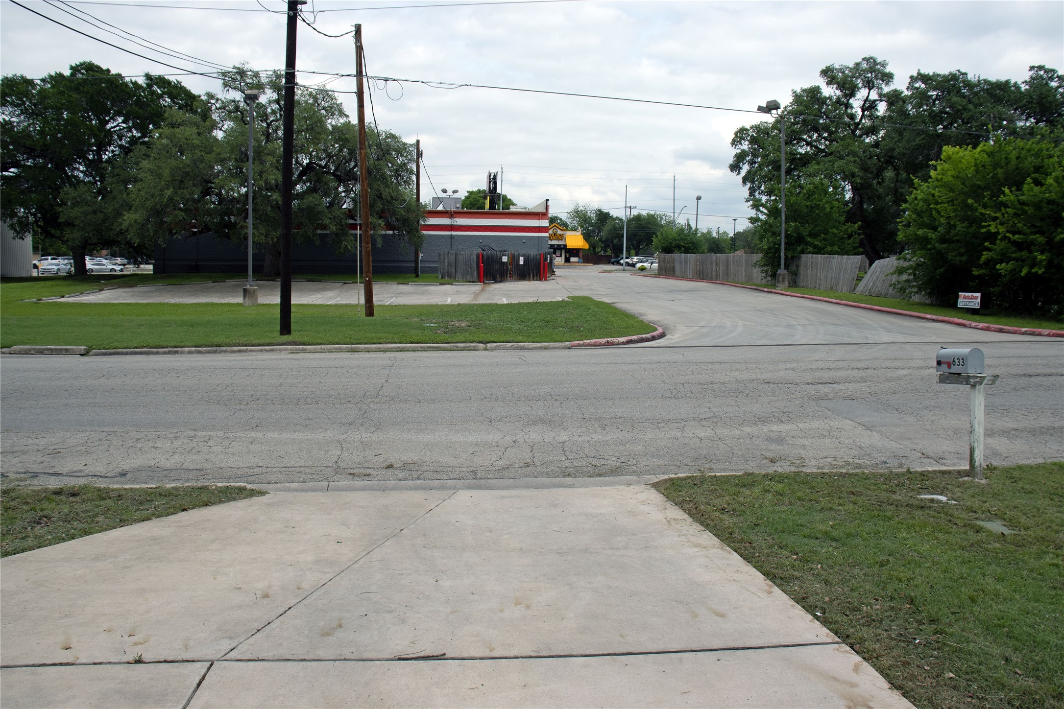 633 South Commerce Street Lockhart, TX 78644 - Photo 29 of 29 Paved driveway entry with a gray mailbox