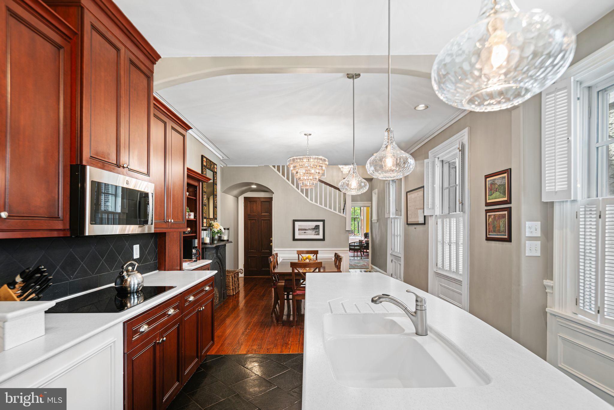 1935 Spring Garden Street Philadelphia, PA 19130 - Photo 14 of 49 a large kitchen with a sink a counter space and stainless steel appliances