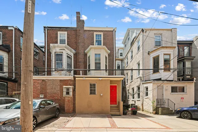 a bedroom with bed and a chandelier