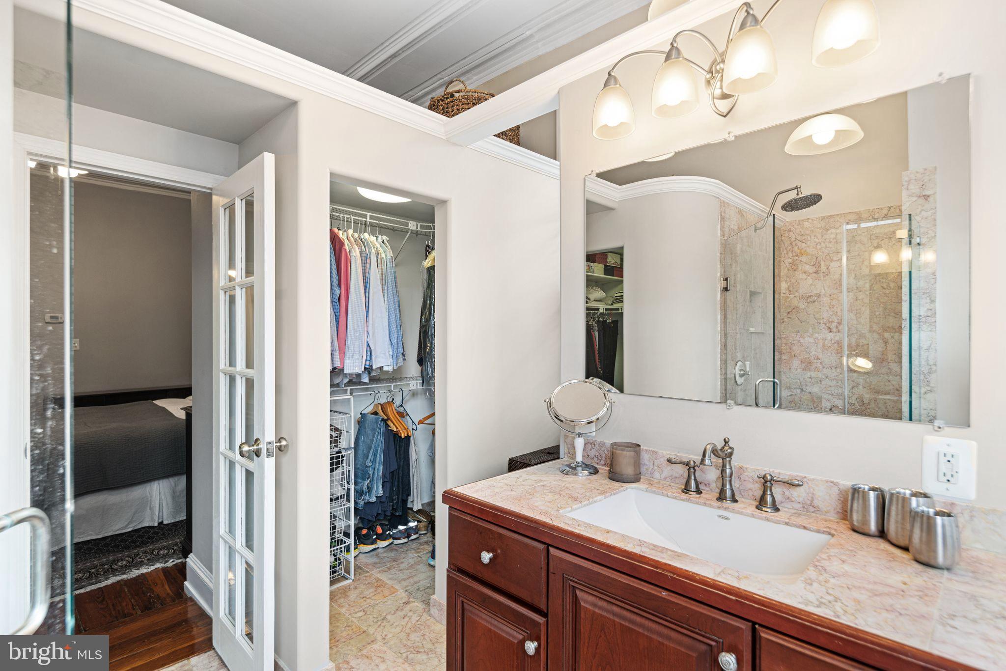 1935 Spring Garden Street Philadelphia, PA 19130 - Photo 21 of 49 a en suite bathroom with a granite countertop sink and a mirror