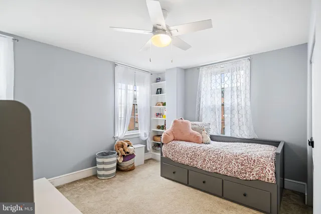 a view of room with flat screen tv and fan