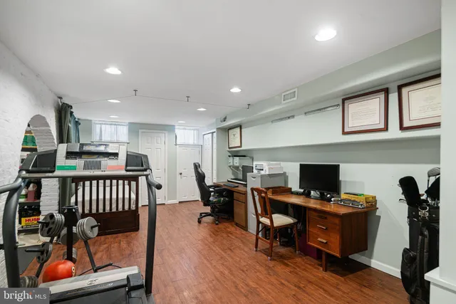 a living room with furniture a window and gym cycle