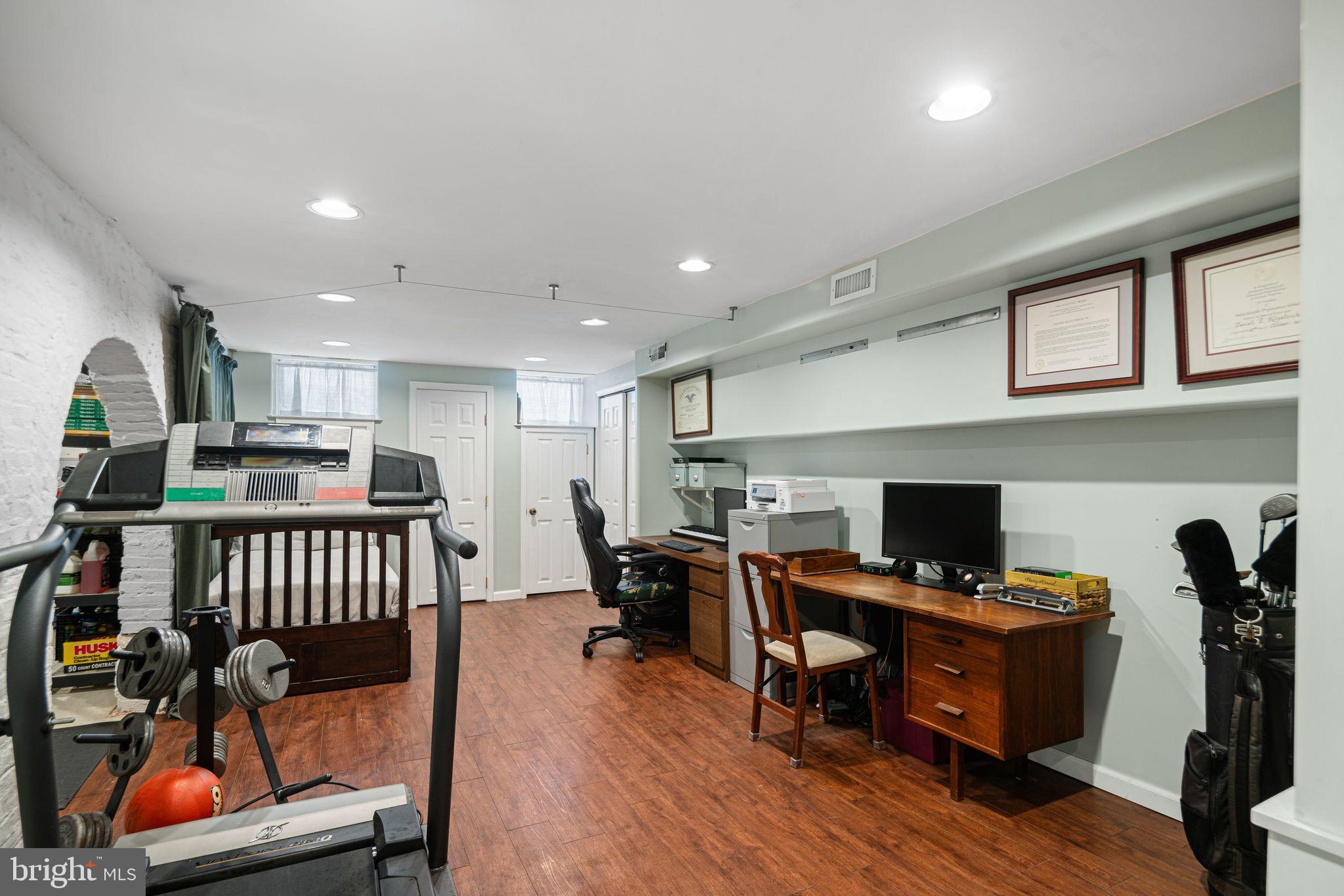 1935 Spring Garden Street Philadelphia, PA 19130 - Photo 30 of 49 a view of a workspace with furniture and wooden floor