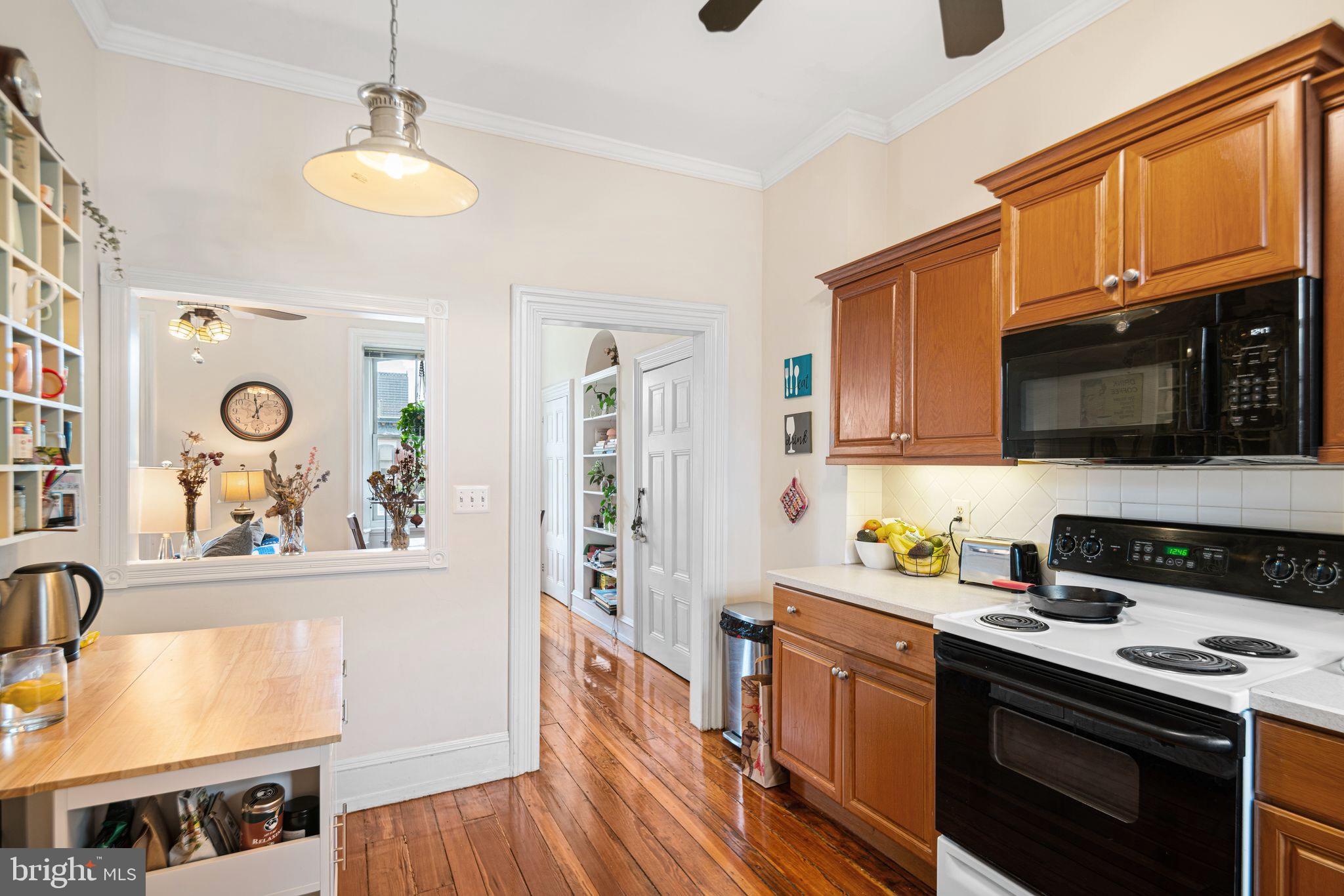 1935 Spring Garden Street Philadelphia, PA 19130 - Photo 41 of 49 a kitchen with stainless steel appliances granite countertop a stove and a wooden cabinets
