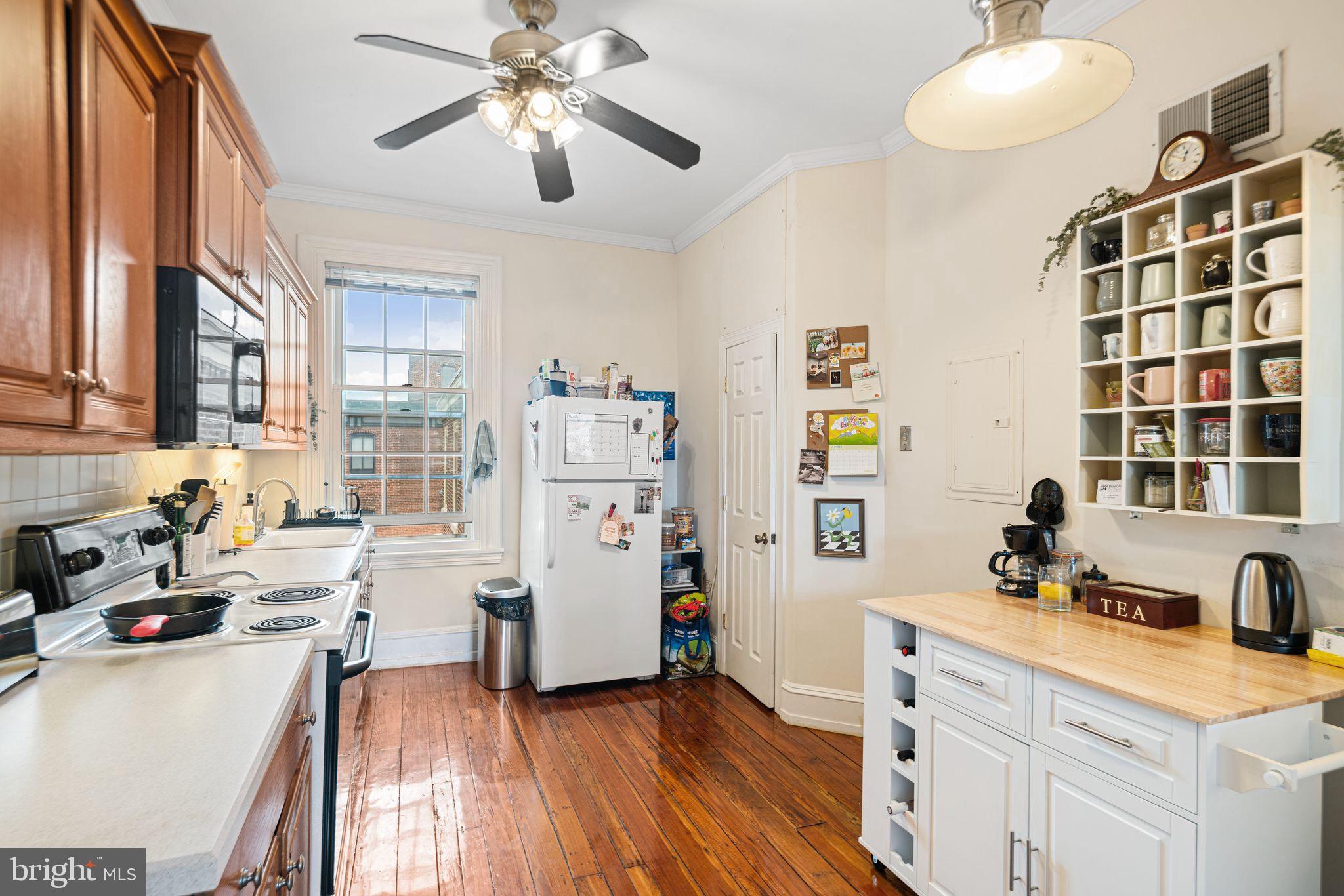 1935 Spring Garden Street Philadelphia, PA 19130 - Photo 42 of 49 a kitchen that has a lot of cabinets a sink and appliances