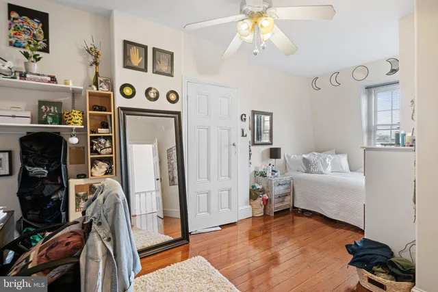 a living room with a bed furniture and a window